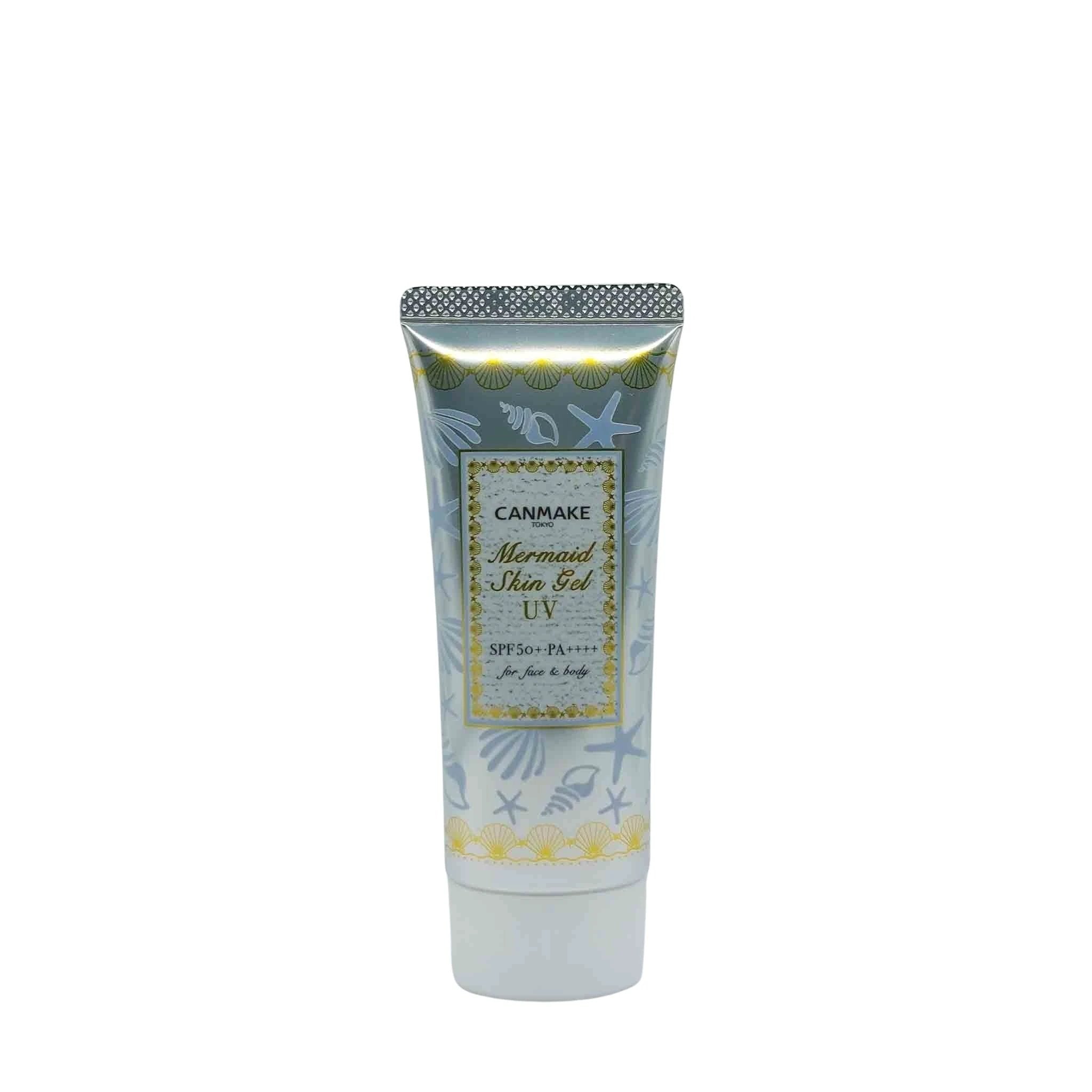 Canmake Mermaid Skin Gel UV sunscreen tube with silver cap, ocean-blue body adorned with shells, gold label.