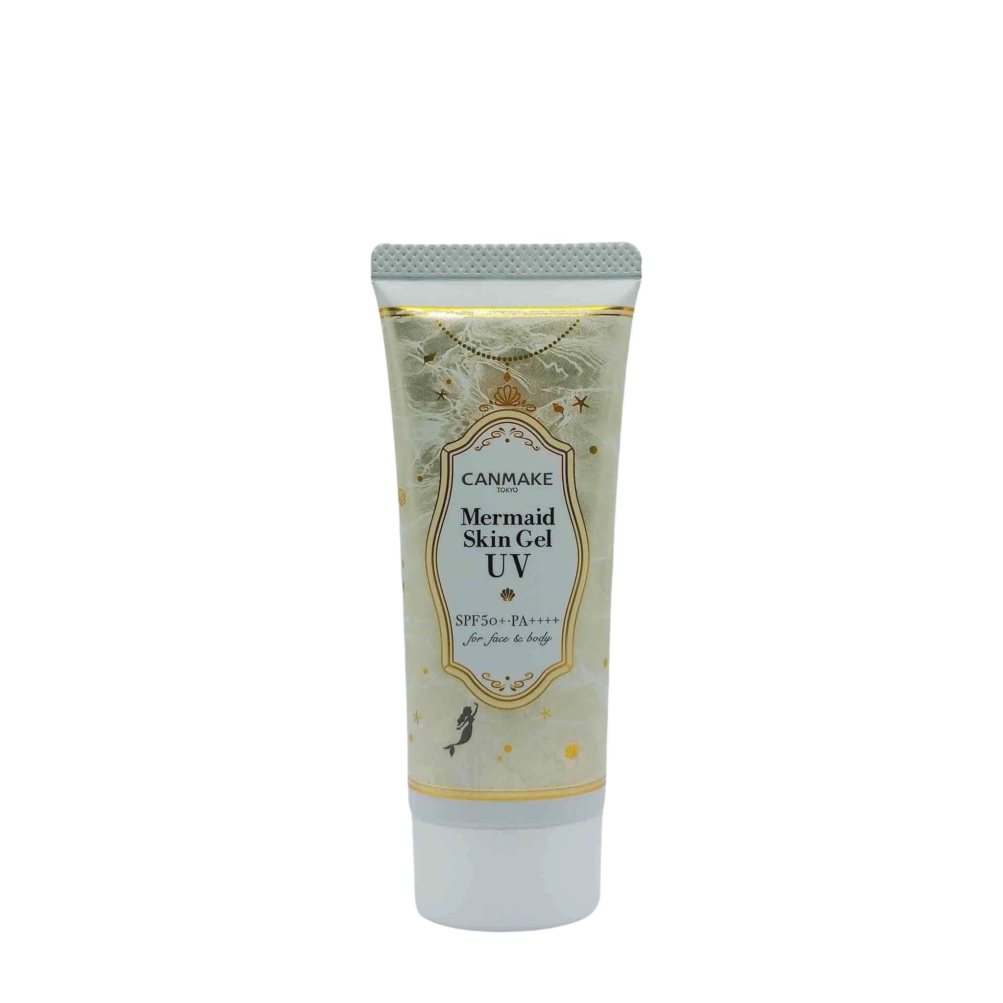 Canmake Mermaid Skin Gel UV sunscreen tube with pale blue label in a gold ornate frame, sea accents, white bottom cap.