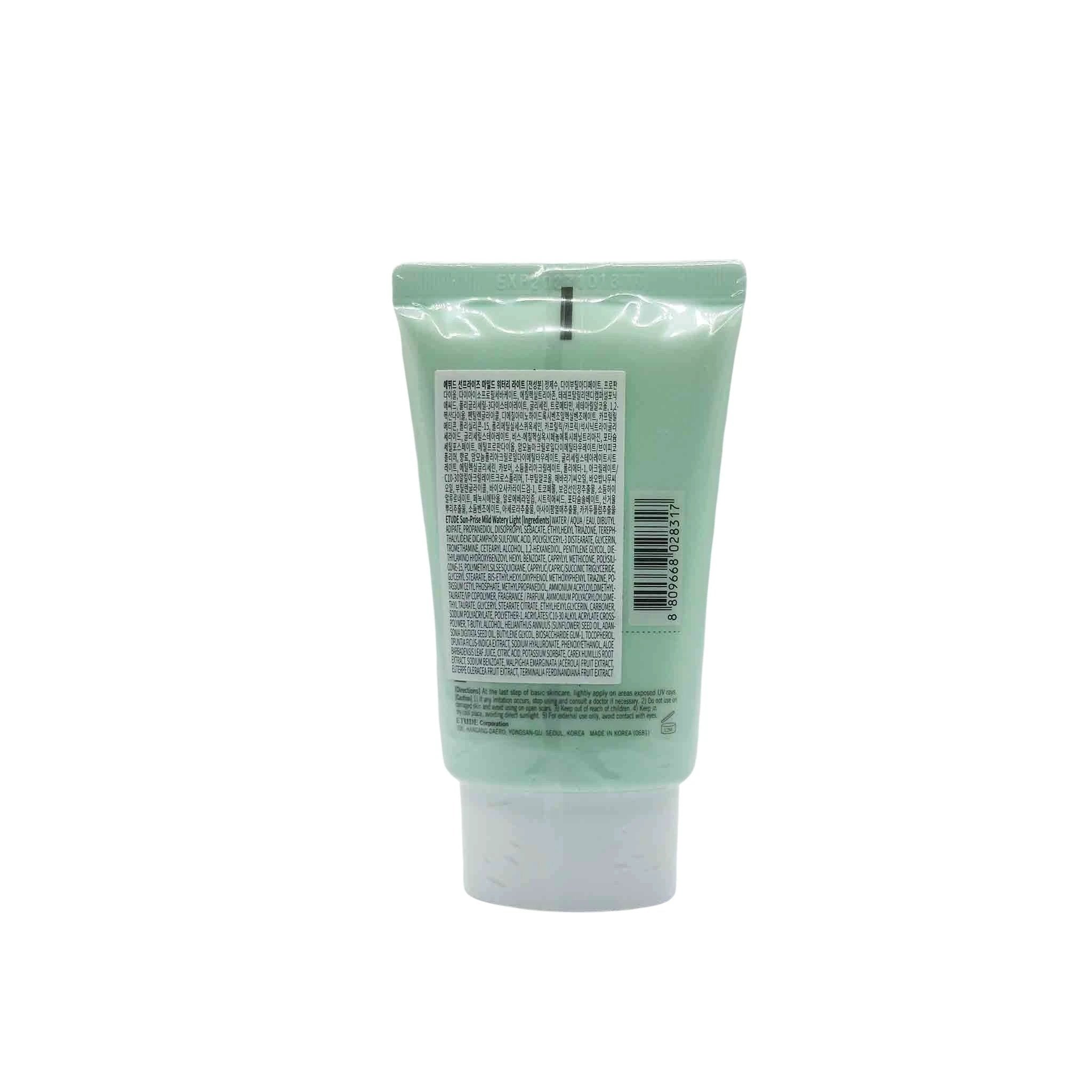 Mint-green sunscreen tube upright with white cap at bottom; back view showing dense small-print label and barcode.