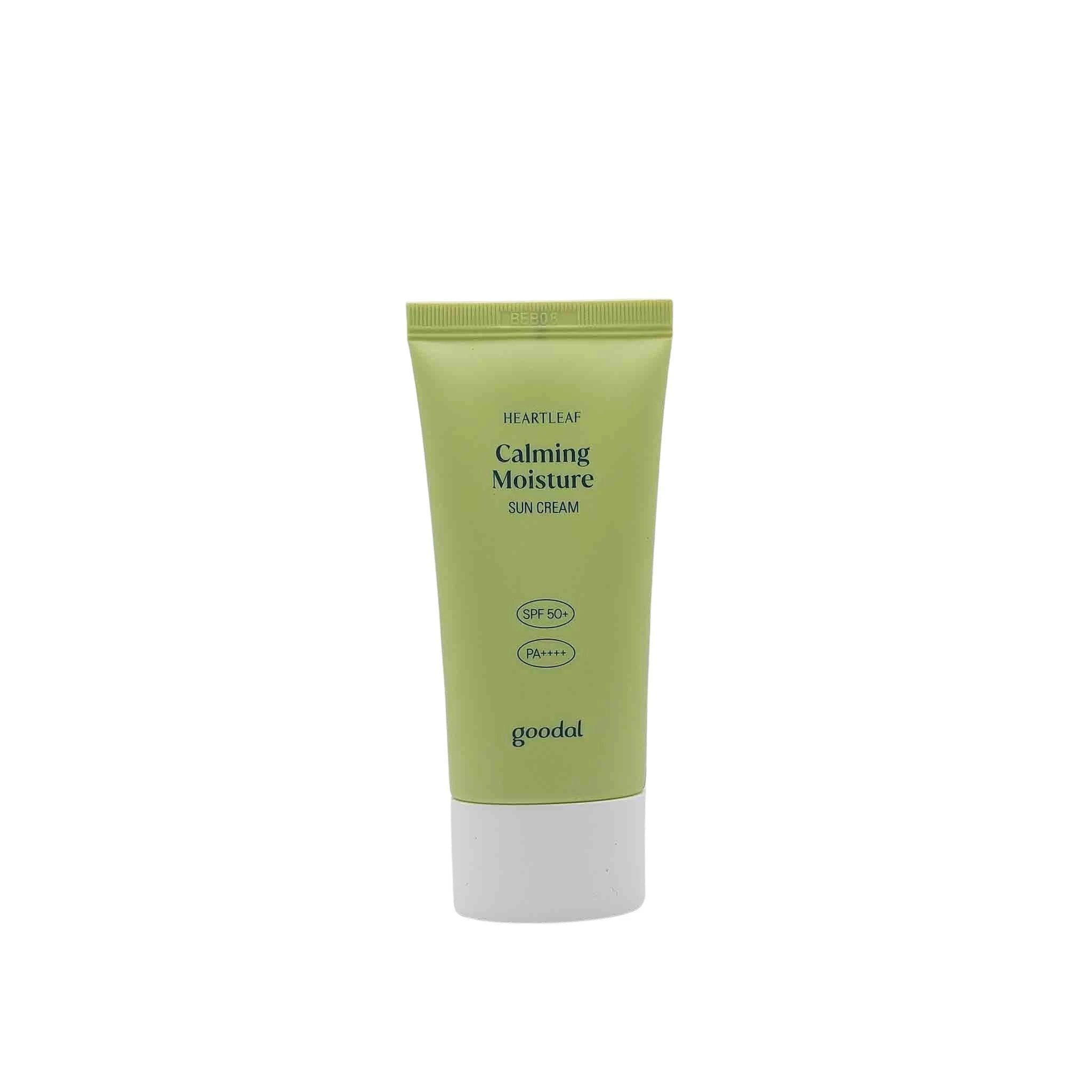 Olive-green squeeze tube with white bottom cap, black text reads Heartleaf Calming Moisture Sun Cream SPF 50+ PA++++, goodal.