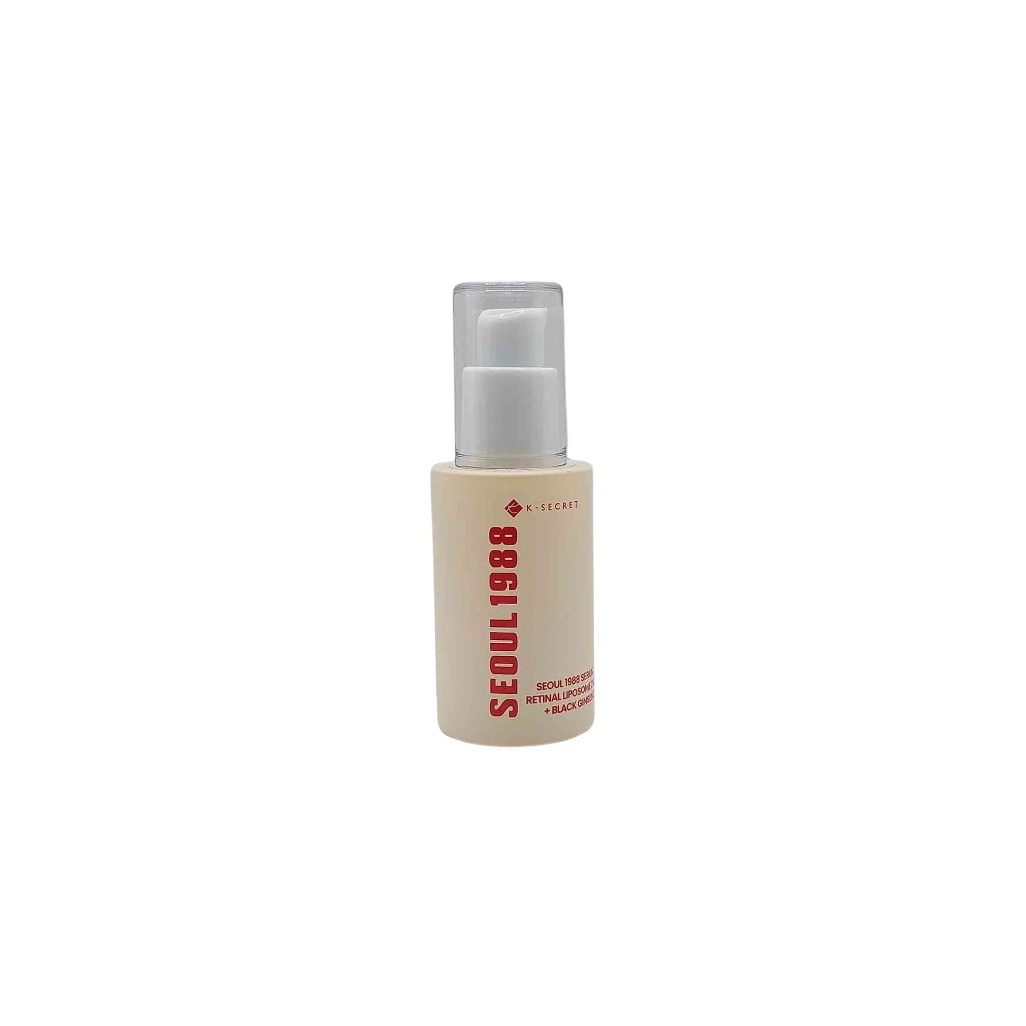 Beige cylindrical serum bottle with clear pump and cap, bold vertical red SEOUL 1988 text and small K-SECRET logo.