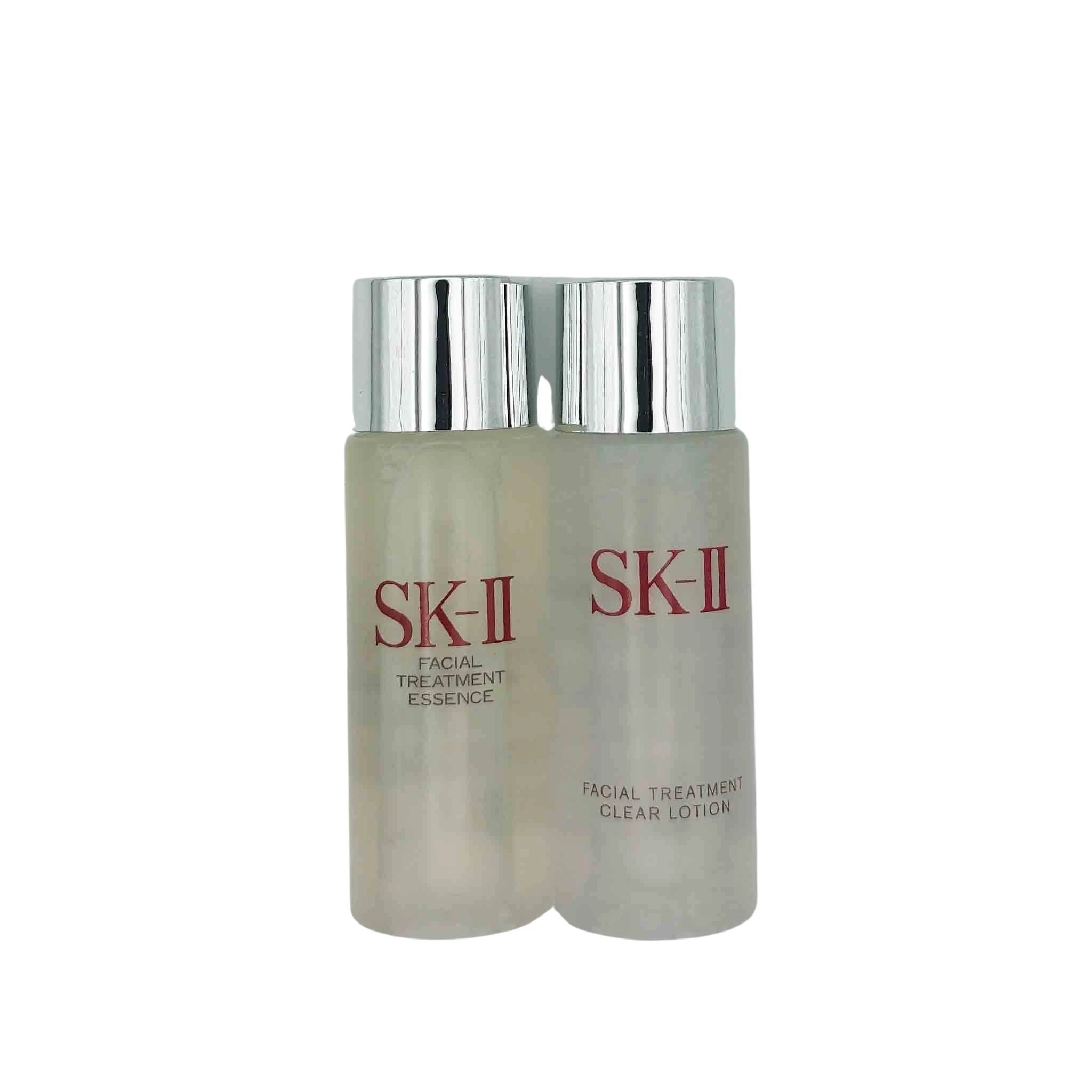 Two frosted SK-II bottles with silver caps, labeled Facial Treatment Essence and Facial Treatment Clear Lotion.