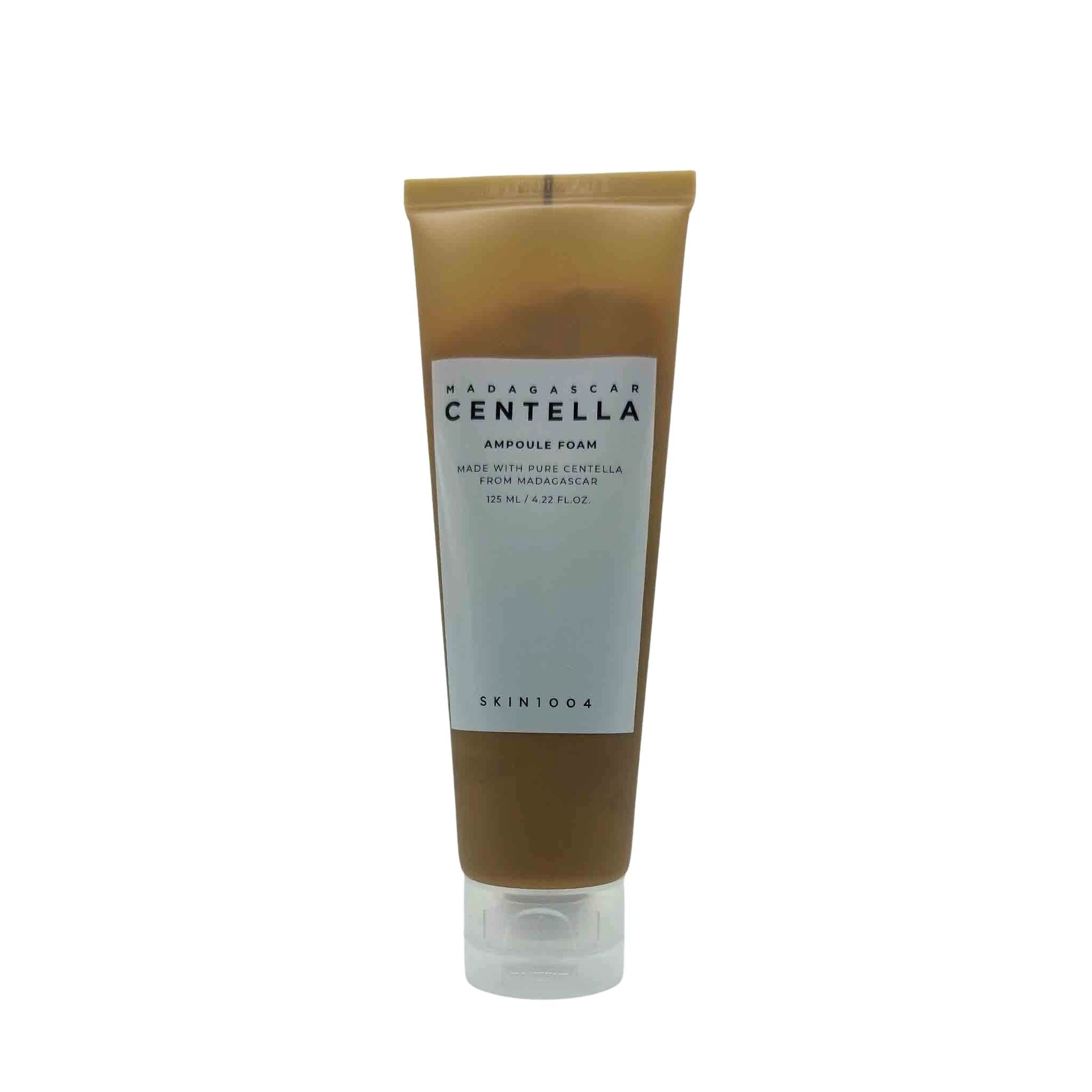 Amber-brown squeeze tube with a white label reading Madagascar Centella Ampoule Foam, clear cap, standing upright.