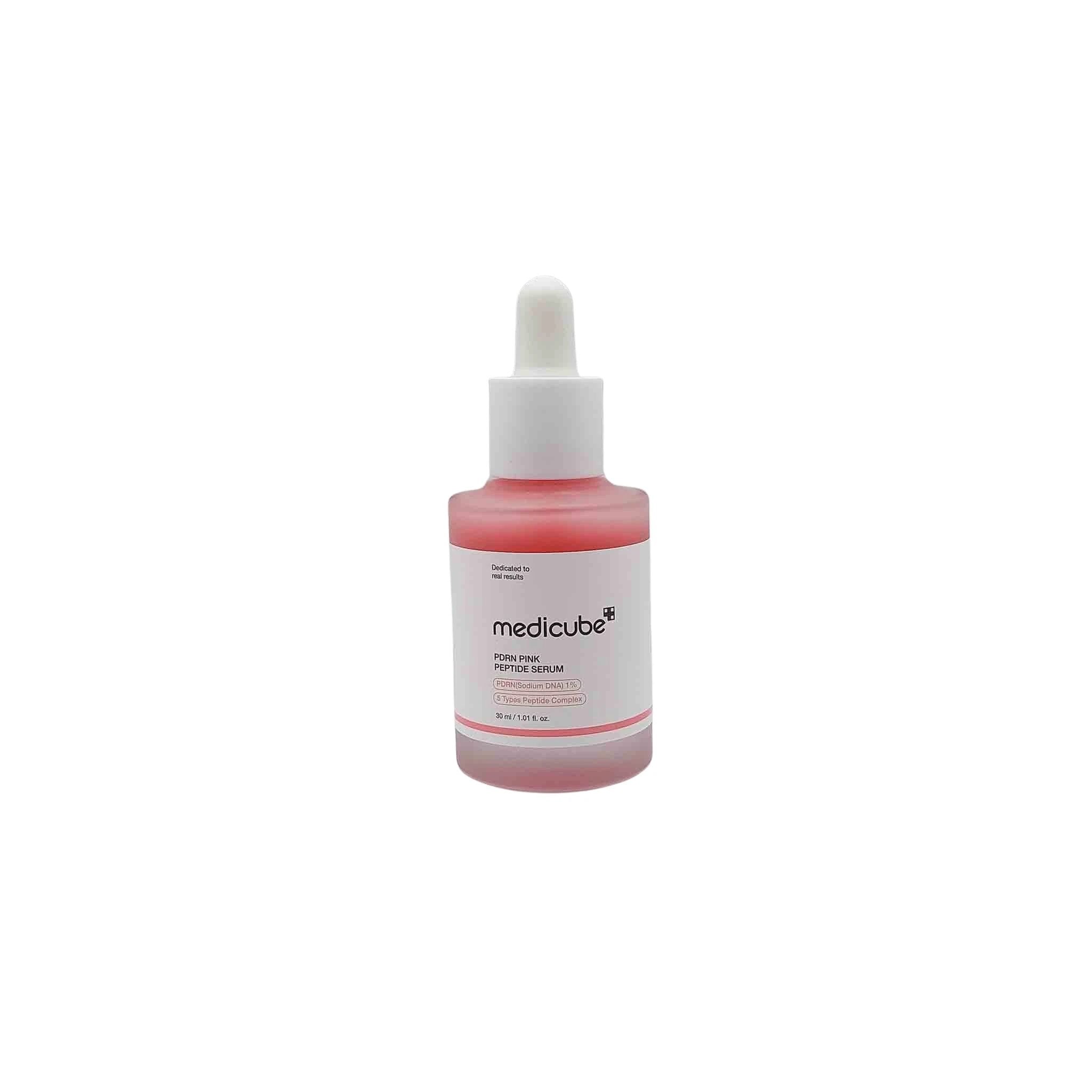 Pink-tinted glass dropper bottle with white cap and white label, pink serum inside and medicube branding.